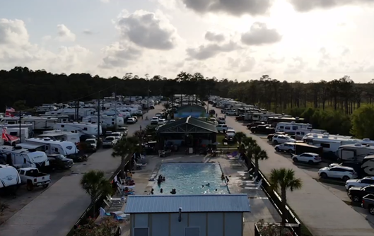 An RV park with a pool in the center