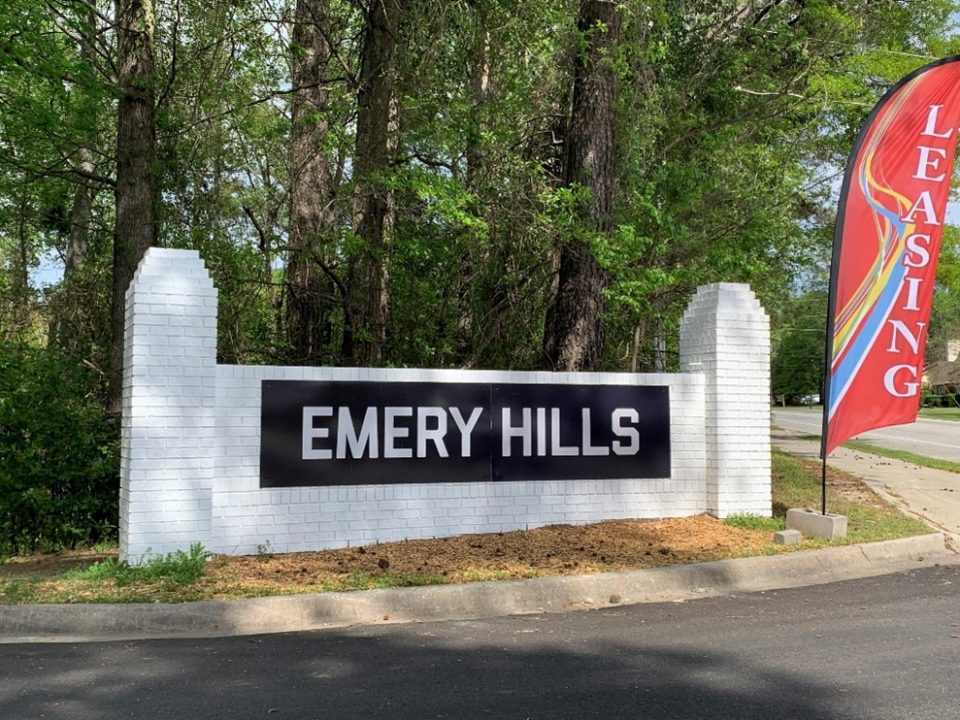 White brick entrance sign for Emery Hills